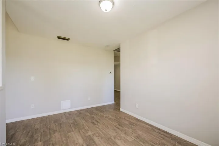 Empty room with wood-type flooring
