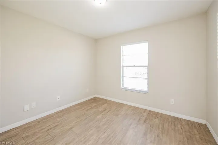 Empty room with light hardwood / wood-style floors