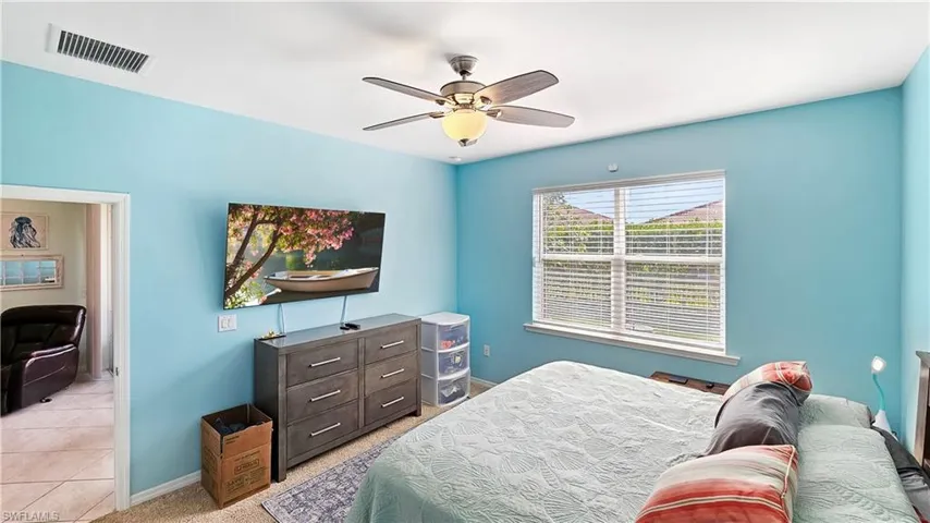 Tiled bedroom with ceiling fan