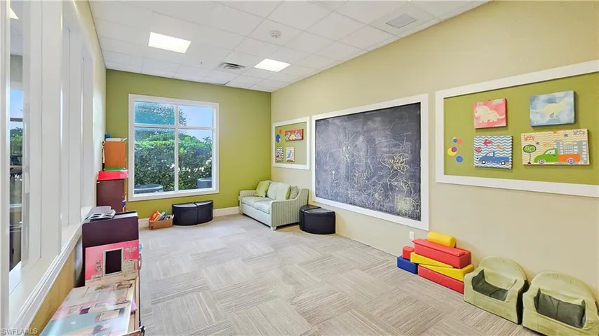 Rec room with a paneled ceiling and light colored carpet