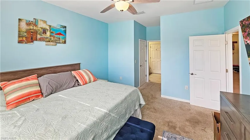 Bedroom featuring ceiling fan and light colored carpet