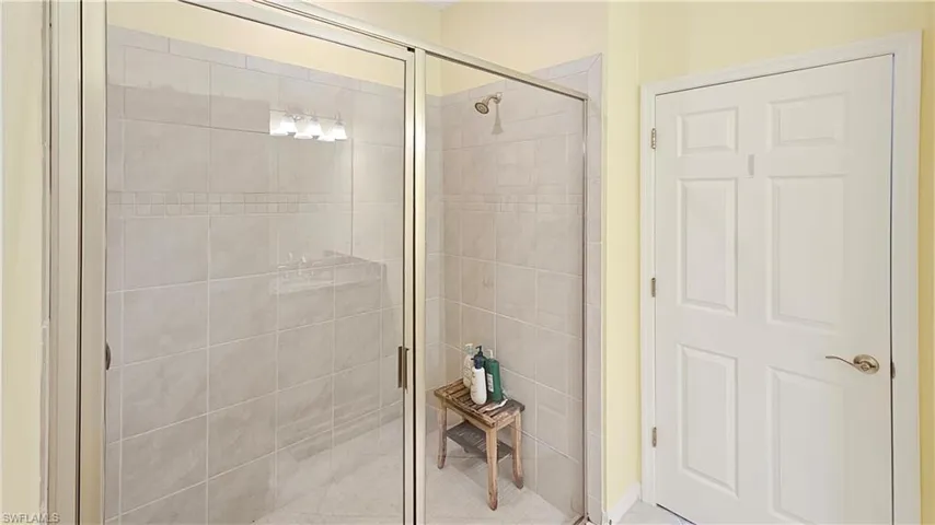 Bathroom featuring a shower with door