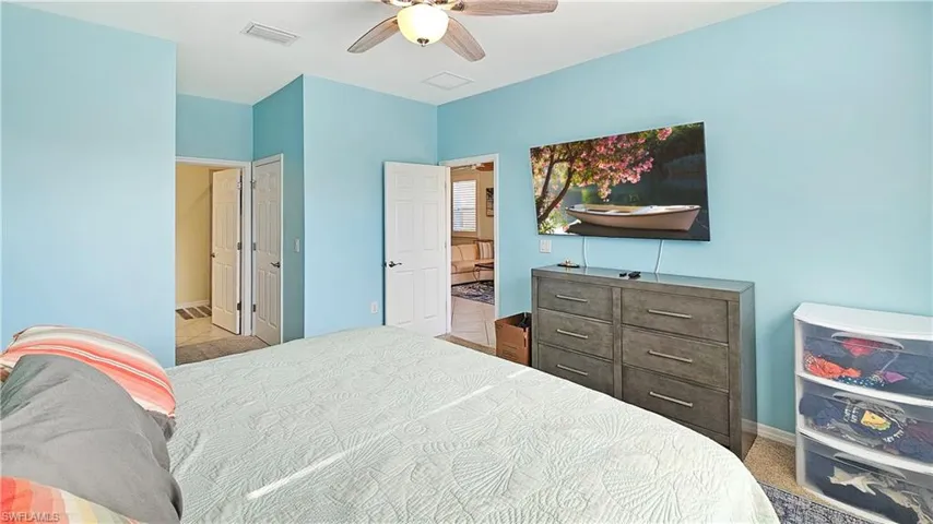 Bedroom featuring connected bathroom and ceiling fan