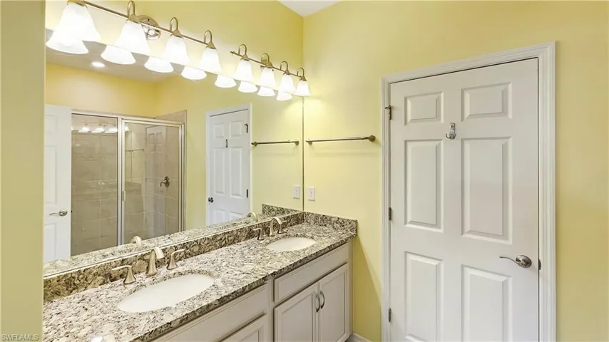 Bathroom with vanity and a shower with shower door