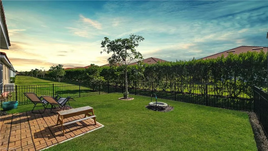 Yard at dusk featuring a patio