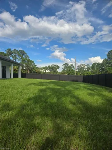 View of yard featuring a garage and driveway