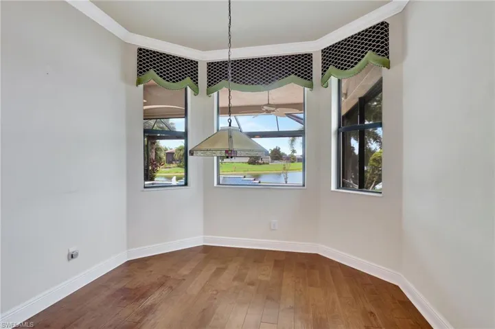 Unfurnished dining area featuring ceiling fan, hardwood / wood-style flooring, and crown molding