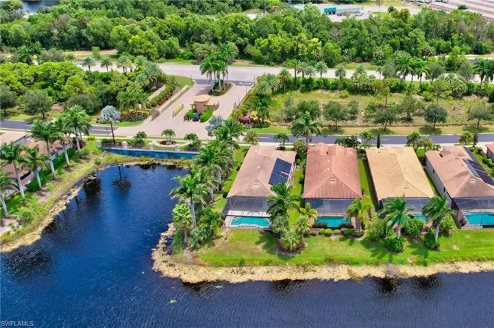 Birds eye view of property with a water view