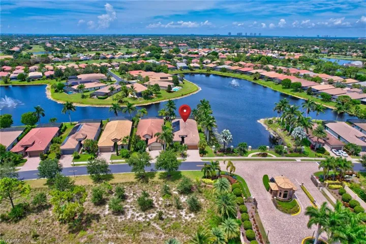 Birds eye view of property with a water view