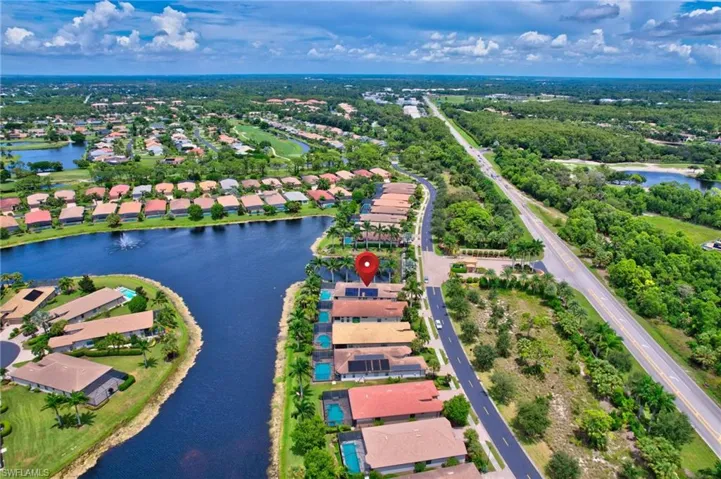 Birds eye view of property with a water view