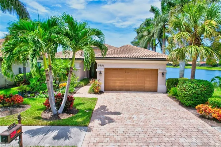 Mediterranean / spanish home with a garage and a water view