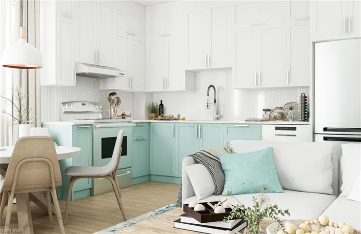 Kitchen with white appliances, backsplash, light countertops, white cabinetry, and light wood finished floors