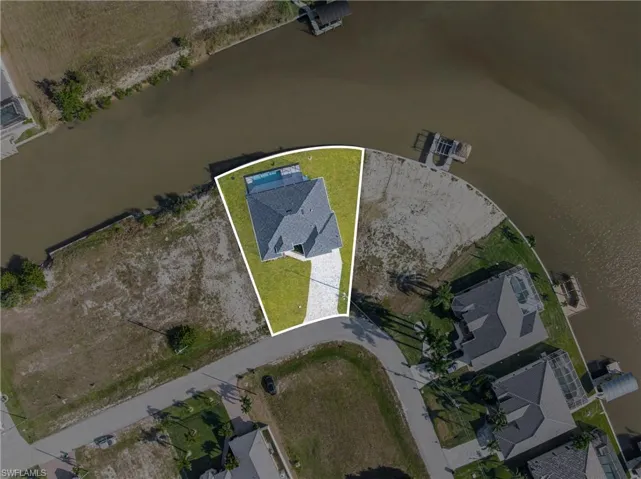 Aerial view of property's location featuring a nearby body of water and property boundaries highlighted