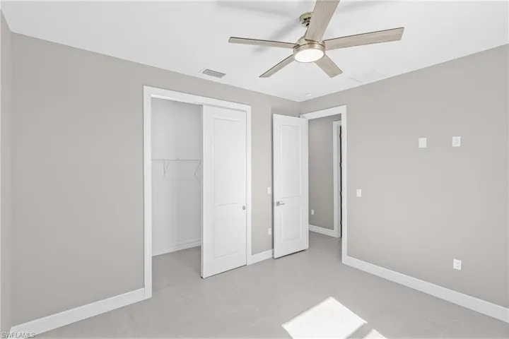 Unfurnished bedroom featuring a ceiling fan and light tile patterned floors
