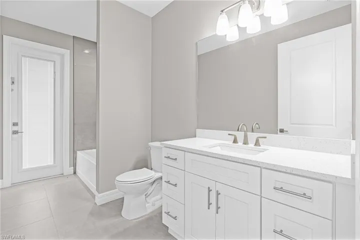 Bathroom with vanity and light tile patterned floors