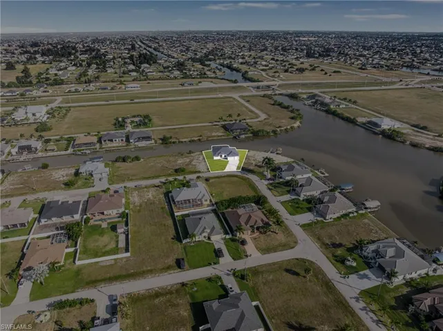 Aerial view of property's location with nearby suburban area and a large body of water