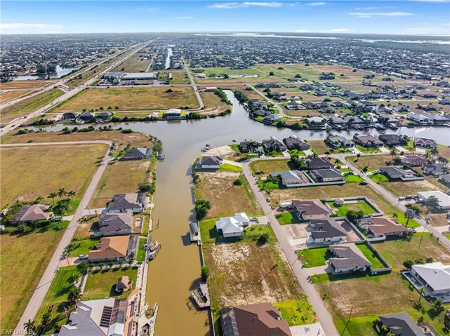 Aerial view of property's location featuring nearby suburban area and a large body of water