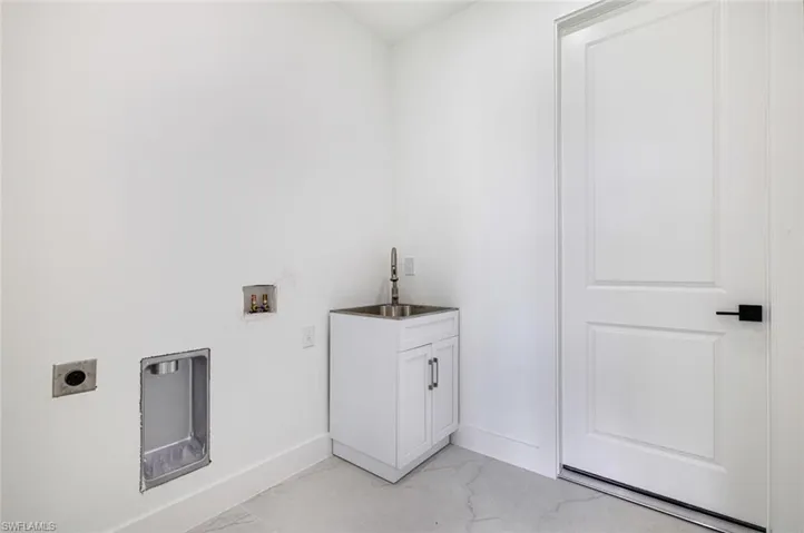 Laundry area featuring light marble finish flooring, hookup for a washing machine, and electric dryer hookup