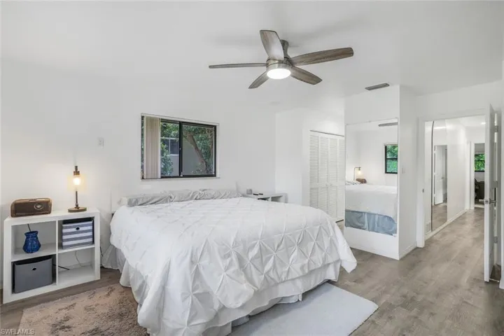 Bedroom with ceiling fan, a closet, and hardwood / wood-style flooring