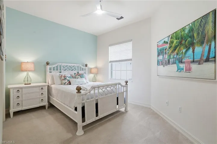 Bedroom featuring ceiling fan and light carpet