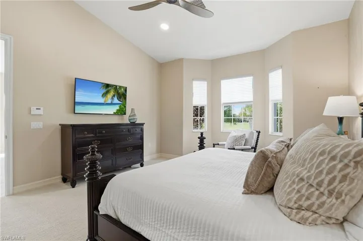 Bedroom with light carpet, ceiling fan, and recessed lighting