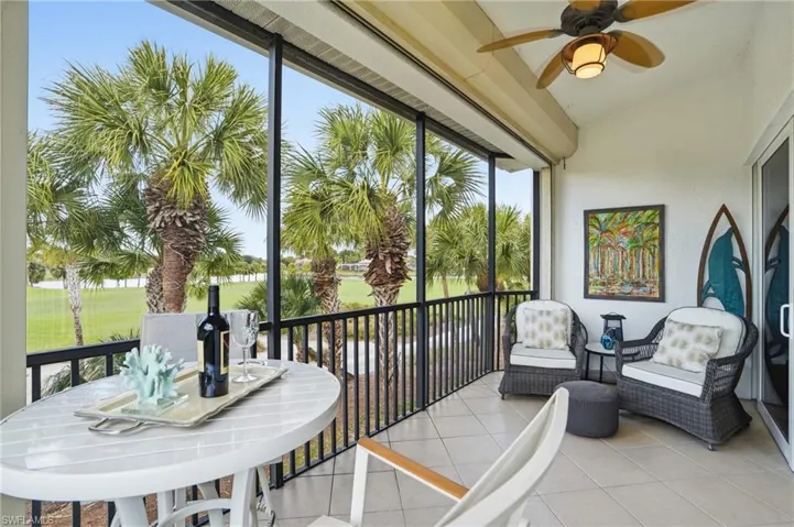 Sunroom with a ceiling fan, vaulted ceiling, a balcony, golf course view, and outdoor dining area