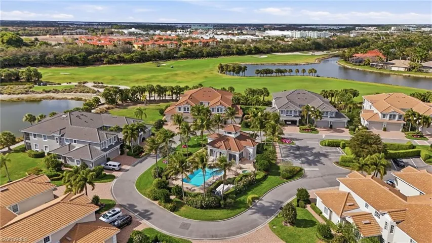 Aerial view of residential area featuring a large body of water and a local golf course
