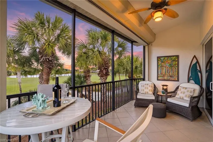 Sunroom with tile patterned floors and vaulted ceiling