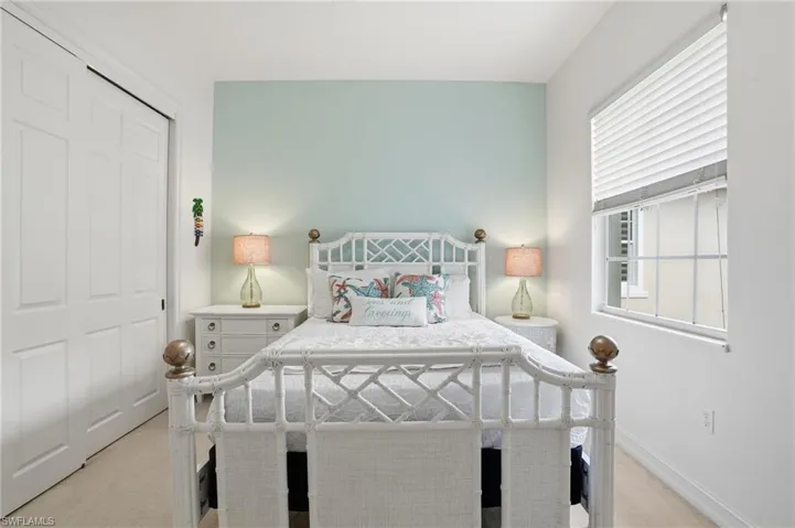 Bedroom featuring light carpet and a closet