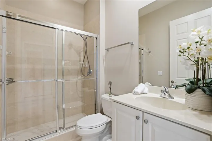 Full bathroom featuring vanity and a shower stall