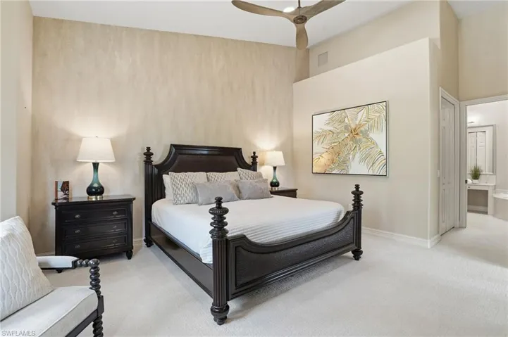 Bedroom featuring carpet floors, ceiling fan, and connected bathroom