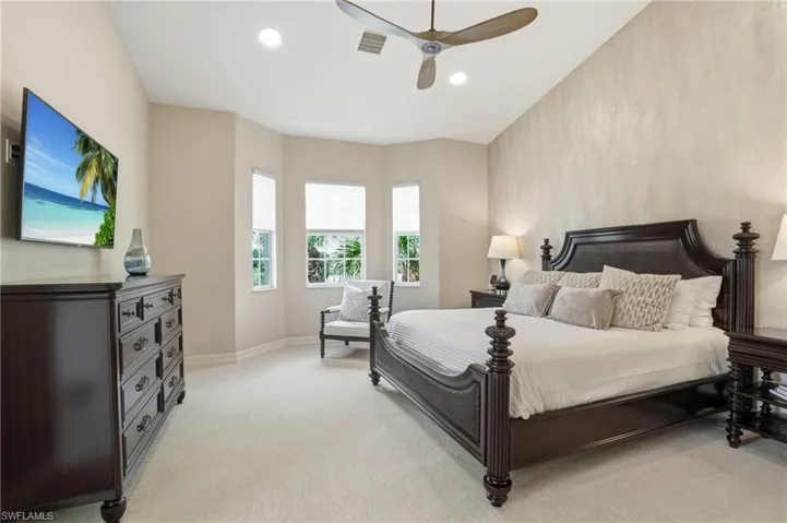 Bedroom featuring light carpet, a ceiling fan, and recessed lighting