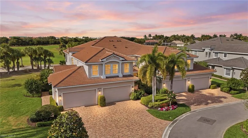 Mediterranean / spanish home with decorative driveway, stucco siding, and a tile roof