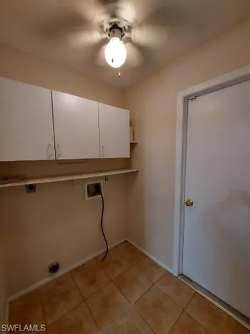 Laundry area with hookup for a washing machine, cabinet space, light tile patterned floors, electric dryer hookup, and a ceiling fan