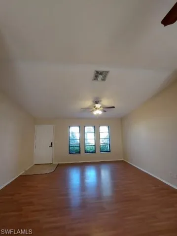 Unfurnished room featuring a ceiling fan and wood finished floors