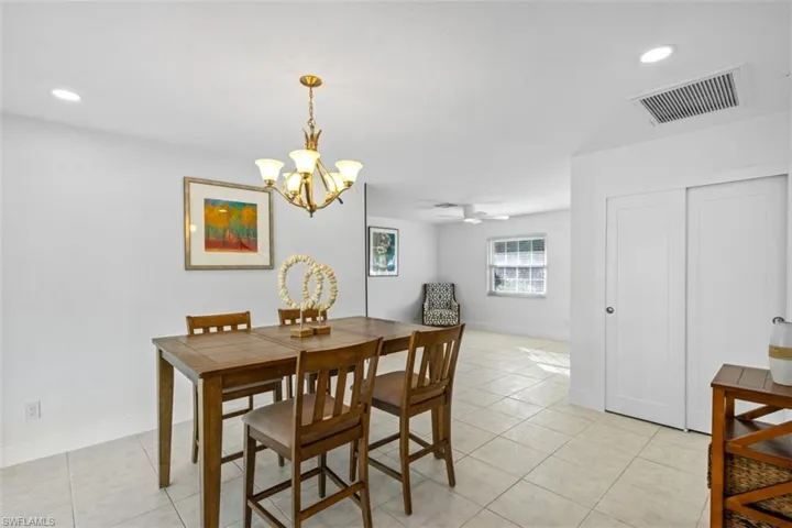 Dining space featuring recessed lighting, light tile patterned floors, a chandelier, and ceiling fan