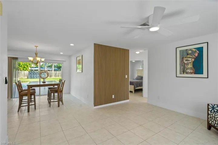 Dining room with a chandelier, recessed lighting, light tile patterned floors, and a ceiling fan