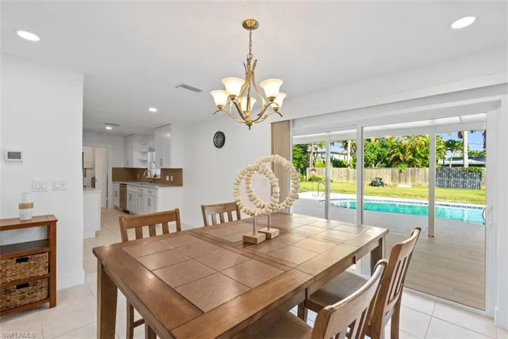 Dining space featuring recessed lighting, light tile patterned floors, and a chandelier