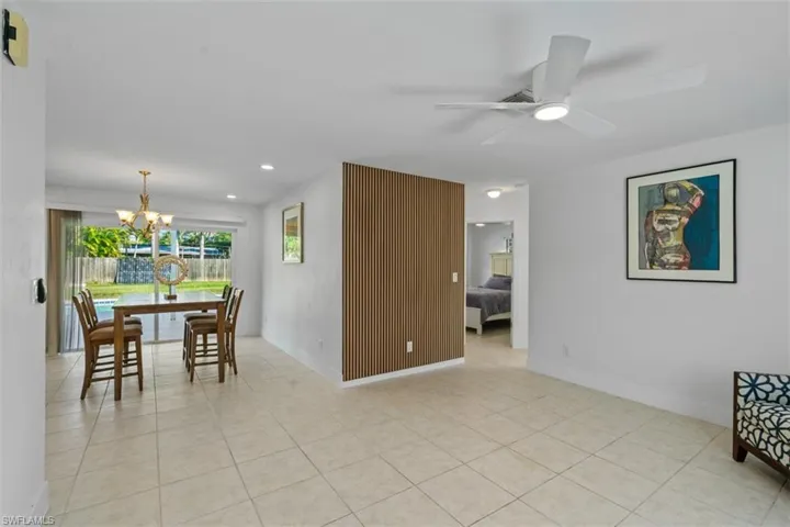 Dining area with a chandelier, recessed lighting, light tile patterned flooring, and ceiling fan