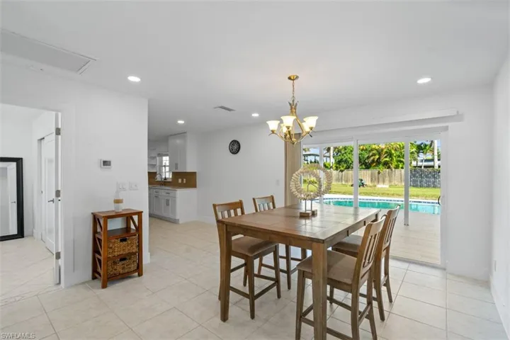 Dining room featuring recessed lighting, a chandelier, and light tile patterned flooring