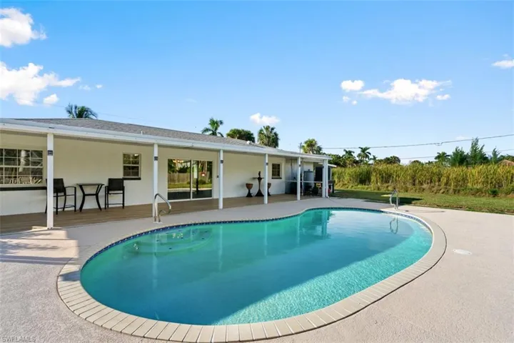 Outdoor pool featuring a patio and a sunroom