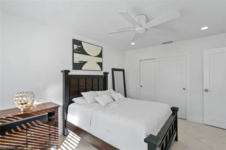 Bedroom featuring recessed lighting, a closet, ceiling fan, and light tile patterned flooring