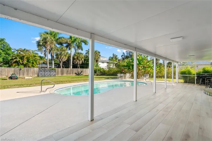 View of swimming pool with a fenced backyard and a patio area