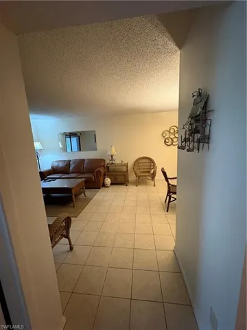 Light-toned square tile flooring extends throughout this interior space