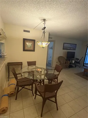 Dining space featuring a decorative Tiffany-style pendant light fixture