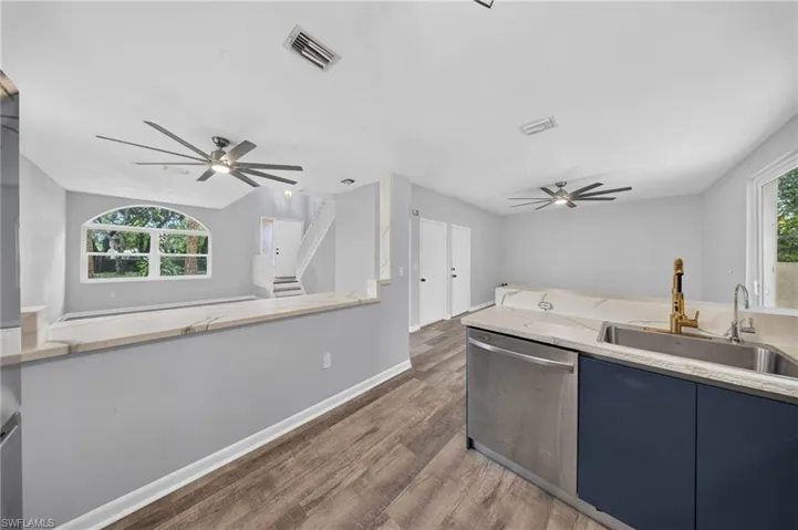 Wood-finish flooring, recessed lighting, and modern ceiling fans