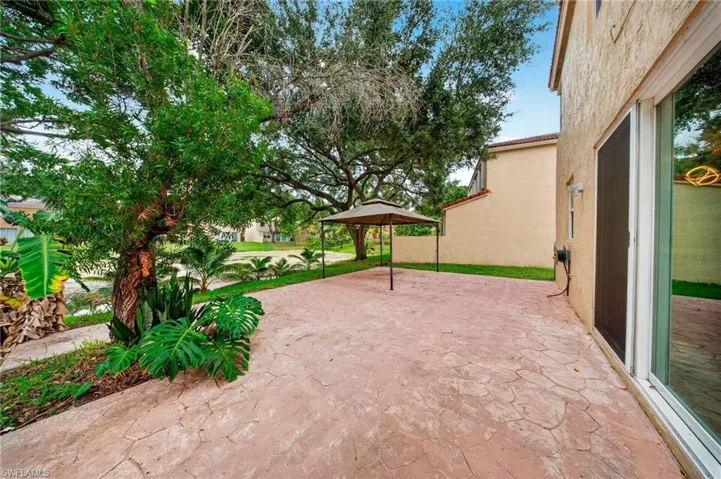 Expansive stamped concrete patio with direct access to the interior via a sliding glass door