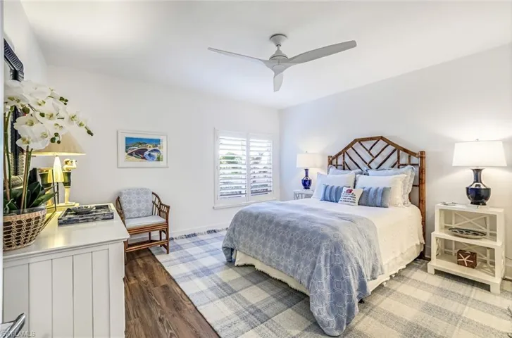 Bedroom with dark wood-style floors and a ceiling fan