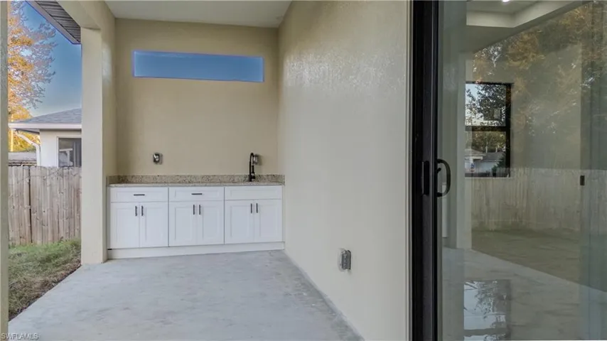 Full bathroom featuring vanity, an enclosed shower, and concrete flooring
