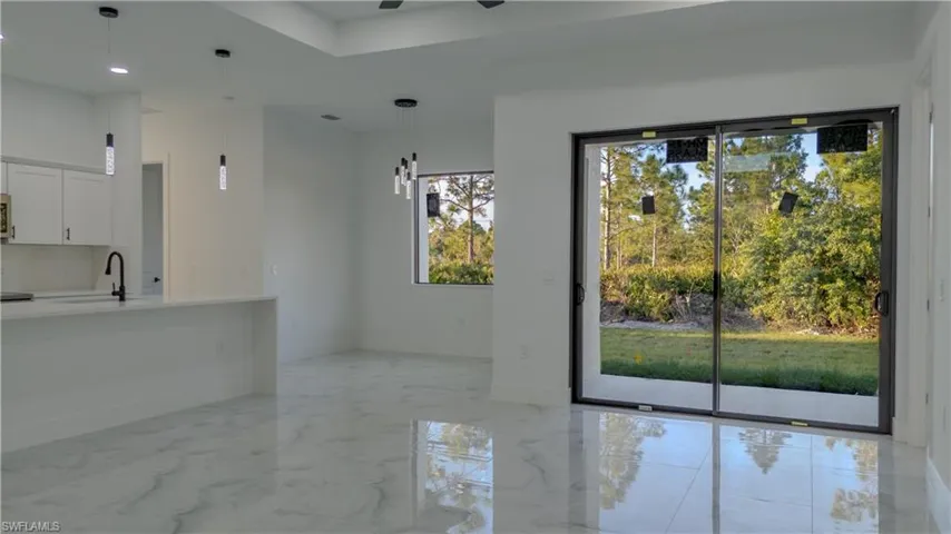 Unfurnished dining area with light marble finish floors, recessed lighting, and ceiling fan